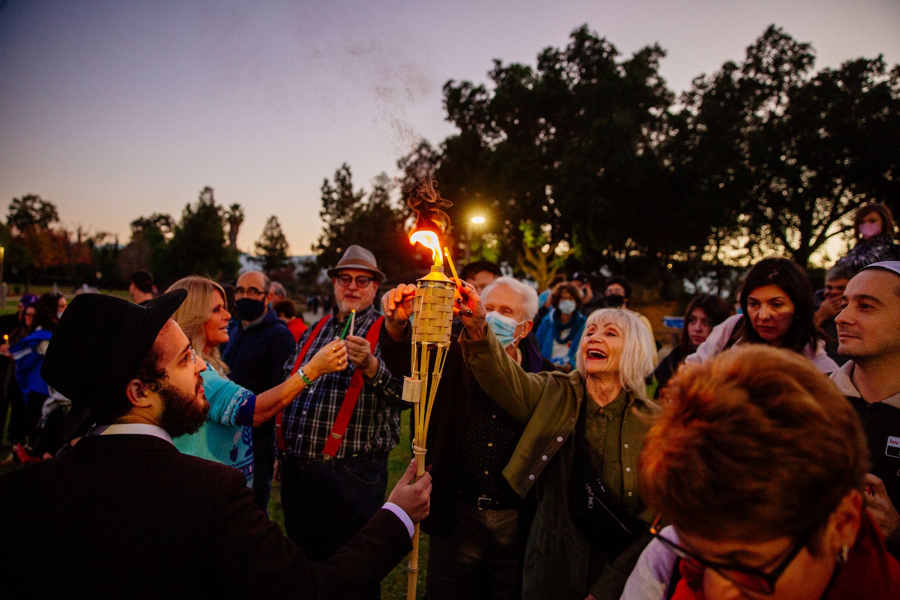 Chanukah torch lighting at dusk