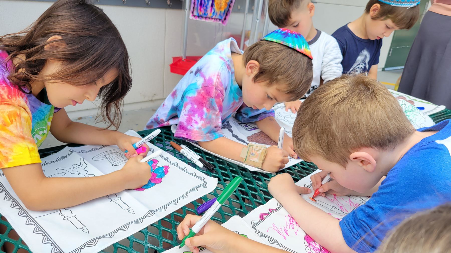 Children coloring with markers